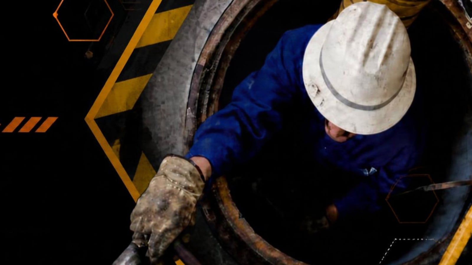 A worker in a hard hat climbing into a confined space, from the course title slide.